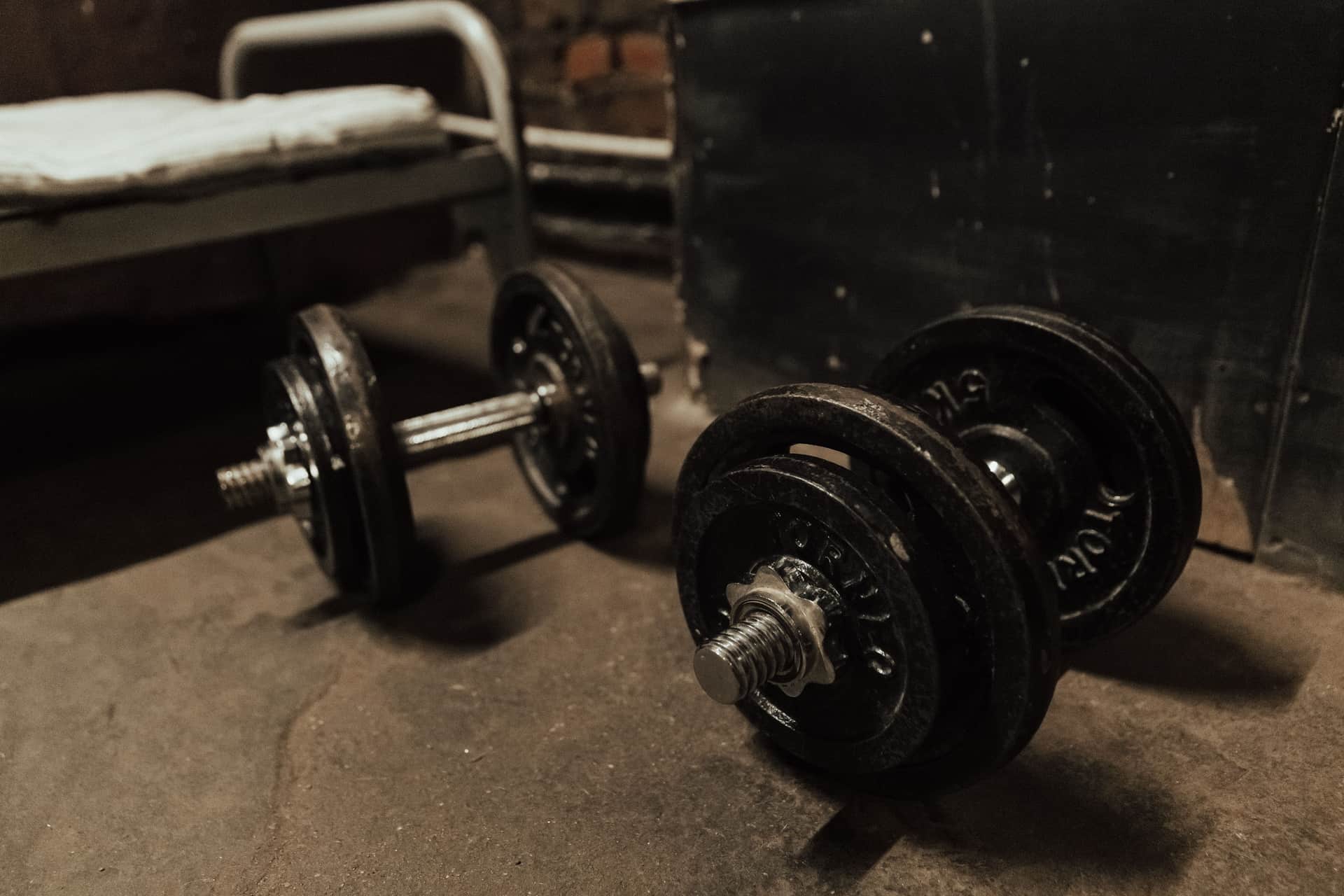 Dumbbells on a concrete gym floor in low light